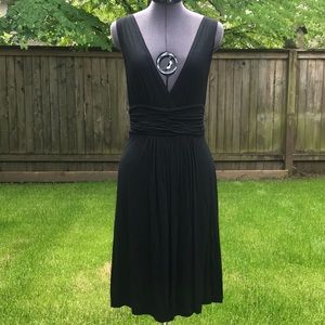 Black plunging V-neck dress.  Skirt is knee length